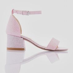 The Bubblegum Glitter Pink Heels designed by Perla for kid girls are the perfect choice for special occasions and dressing up. These stylish heels feature a block heel, providing both stability and a touch of elegance. The sandal buckle strap ensures a snug fit, while the matching strap across the front of the foot adds extra security and style. The sparkly finish gives these heels a dazzling look, making any outfit stand out. Additionally, the pink logo print on the sole adds a unique and playful touch. Ideal for parties, events, or simply feeling glamorous, these heels combine comfort and fashion seamlessly. The Bubblegum Glitter Pink Heels designed by Perla for kid girls are a must-have for any young fashionista's wardrobe. Block heel Sandal buckle strap Matching strap across the front Pink Glitter Heels, Heels Pink, Stylish Heels, Glitter Heels, Pink Heels, Heel Sandal, Pink Logo, Bubblegum Pink, Designer Heels