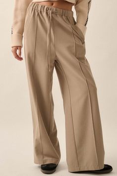 Solid twill pants. Drawstring elastic waist. Hip pockets. Wide leg. Pintuck detail. Full length. Loose fit. 70% Tencel, 25% Rayon, 5% Spandex. Imported. Designed in LA. Model wears size S. Twill Pants, Pin Tucks, Drawstring Pants, Mocha, Elastic Waist, Full Length, Wide Leg, Loose Fitting, Spandex