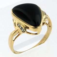 Our elegant 4.1ct onyx ring is set in 14kt yellow gold framed by  diamonds totaling .04ct. SKU: 02Y75M   Item: Black Onyx Ring set in Yellow Gold  Stone Weight: 4.1ct Onyx  Gold: 14kt Yellow  Diamond Weight: .04ct Length: 1/2" Formal Onyx Gemstone Rings, Formal Onyx Diamond Ring With Gemstone, Formal Onyx Diamond Ring Fine Jewelry, Formal Onyx Diamond Ring In Fine Jewelry Style, Formal Yellow Gold Onyx Rings, Oval Ring, Black Onyx Ring, Garnet Earrings, Oval Rings