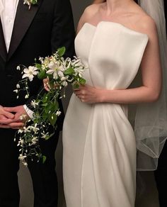 a bride and groom standing next to each other