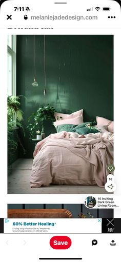 an image of a bed in a room with green walls and plants on the wall