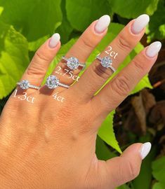 a woman's hand with three different rings on it and the size of each ring