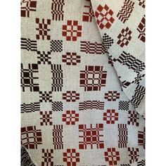 a red and white quilt with squares on it