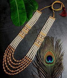 RAADHE CREATION's First time ever MONALISA pearl Multiple layers beaded long necklace from RAADHE CREATION is best pick for groom. The metal crafted Brass studded with sparkling stones and Pearl made from golden finish metal. It is woven with MONALISA pearl beads and comes with adjustable dori. So that it could be adjusted properly with your wedding sherwani. Brides are upping their game as it is, but grooms are no less too! Here are some Premium groom necklaces which spotted some unique accesso White Temple Jewelry Beaded Necklaces For Wedding, White Temple Jewelry Beaded Necklace For Wedding, Traditional Beaded Long Bridal Necklace, Traditional Long Bridal Necklace With Pearl Chain, White Latkans Necklace For Wedding, White Wedding Necklaces With Latkans, Temple Jewelry Style Wedding Mala Long Necklace, Temple Jewelry Style Wedding Mala, Gold Beaded Necklaces With Stone Work For Wedding