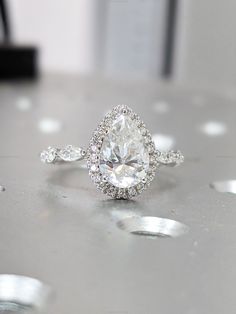 a diamond ring sitting on top of a table