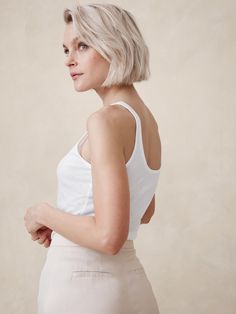 Ideal for channeling the season's ode to 90s sheer styles, this fitted tank is cut from a semi-sheer, ribbed fabric so you can layer it or wear it solo as you please.  Fitted.  Sustainability: Made with TENCEL™ lyocell, a sustainably sourced fiber from responsibly-harvested trees.  Scoop neck.  Straight hem.  Fitted.  Sleeveless.  Hip length.  Model: Size S, 5'10" (178cm). Fitted Vest, Woman Vest, High Waisted Cropped Jeans, Flower Girl Tutu, Top Banana, Ribbed Tank Top, Plus Size Shopping, Ribbed Tank, Set Outfit