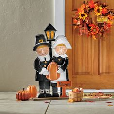 a couple of figurines sitting on top of a table next to a door