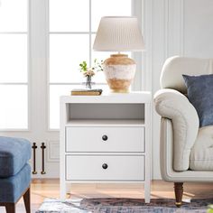 a living room scene with focus on the end table and chair next to the couch