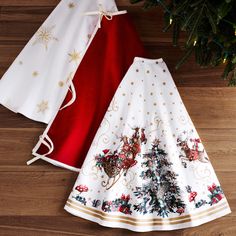 two christmas themed skirts sitting on top of a wooden floor