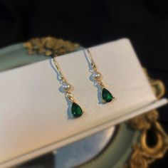 Introducing our stunning minimalist teardrop emerald gold and pearl drop earrings! Handcrafted with care and attention to detail, these earrings are the perfect blend of classic and modern style. The teardrop-shaped emerald gemstones are delicately set in 18k gold plated, giving these earrings an elegant and timeless look. The addition of the lustrous cultured pearls adds a touch of sophistication to these already stunning earrings. Measuring approximately 31mm in length, 5mm width, these earrin Green Teardrop Pearl Earrings For Wedding, Gold Pearl Drop Earrings For May Birthstone, Elegant Teardrop Earrings For May Birthstone Gift, Elegant Pear-shaped May Birthstone Earrings, Elegant Green Teardrop Pendant Earrings, Classic Green Pearl Drop Earrings, Green Elegant Pearl Drop Earrings, Elegant Green Teardrop Earrings For Anniversary, Elegant Dangle Pearl Earrings For May Birthstone