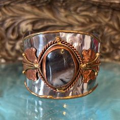 This Is A Gorgeous Agate Cuff. Hand Crafted With Silver Tone, Metal Brass, And Copper. Beautiful Agate Stone In The Center. Has The Look Of Handmade In That Beautiful Rustic Design. This Is Just Over 2 Inches Wide At The Widest Point. Will Fit Up To A 7 Inch Wrist. I Will Include A Gift Box For You.