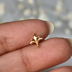 "Inspired from the beautiful Mughal motifs, this gold floral stud is a perfect piece for all your piercings. Crafted in 14k solid gold, this one of a kind pin makes for a great gift for a piercing lover and your loved ones. Great for your tragus, lobe, conch, helix, flat piercing. It also makes for a mesmerizing nose jewelry. * Dimension : 7x7mm (approx.) * Material : 14k Solid Gold If you like this stud, please press \"Pin it\" button on the top of your screen. Follow us on Instagram : @abhikaj Elegant Hypoallergenic 14k Gold Nose Rings, Gold Dainty Tarnish-resistant Cartilage Earrings, Dainty Gold Cartilage Earrings Tarnish Resistant, Dainty Gold Tarnish-resistant Cartilage Earrings, Gold Nose Studs For Wedding, Dainty Hypoallergenic Yellow Gold Nose Stud, Tiny Dainty 14k Gold Nose Studs, Internally Threaded 14k Yellow Gold Nose Rings, 14k Yellow Gold Internally Threaded Nose Rings