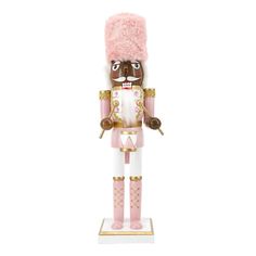 a toy nutcracker with pink fur on it's head