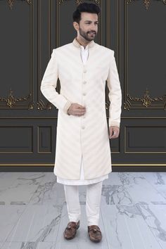 Stay stylishly cool with our Mens Sherwani featuring an open collar. Perfect for any occasion, this Sherwani adds a touch of class to your ensemble. Upgrade your wardrobe now with R14-S77. Classic Fitted Sherwani With Naqshi Detailing, Classic Sherwani With Naqshi For Wedding, Classic Cream Sherwani For Festive Occasions, Designer Cream Kurta For Formal Occasions, Long Nehru Jacket For Eid, Classic Long Sleeve Sherwani With Naqshi, Classic Fitted Naqshi Kurta, Classic Dabka Sherwani For Eid, Classic Fitted Sherwani For Eid