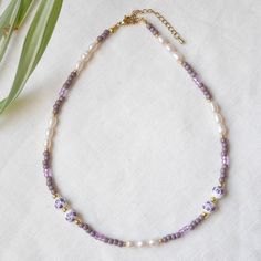 Lavender pearl necklace is a beautiful and serene beaded necklace. In this necklace, I have paired lilac and white flower ceramic beads, with rice-shape freshwater pearls, lavender and lilac glass seed beads and 14k gold or silver-plated beads.  Available gold- or silver-plated with stainless steel.  Choose the length of your necklace: - 15 inches (38 cm - in the photos), with a 2 inches (5 cm) extension chain - so you can adjust the length of your necklace between 15 inches and 17 inches (38 - 43 cm), or - 17 inches (43 cm), with a 2 inches (5 cm) extension chain - so you can adjust the length of your necklace between 17 inches and 18 inches (43 - 48 cm cm), or If you would like to have the necklace shorter or longer, just send me a message - I'm happy to personalize this necklace for you Adjustable Single Strand Lavender Beaded Necklace, Adjustable Lavender Single Strand Beaded Necklace, Purple Single Strand Beaded Necklace Gift, Gift Purple Single Strand Beaded Necklace, Purple Single Strand Beaded Necklace For Gift, Purple Single Strand Beads For Gift, Purple Single Strand Beads As A Gift, Single Strand Purple Beads For Gift, Purple Pearl Necklaces With Round Beads