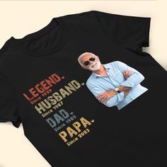 a black t - shirt with an image of a man wearing sunglasses