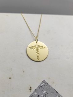 WE SHIP ALL PARCELS IN ONE BUSINESS DAY FOR FREE AND PROVIDE THE SPEEDIEST DELIVERY! Engraved Nurse Design Necklace - Medical Pendant Necklace - Handmade Nurse Gold Jewelry - Engraved Nurse Gold Necklace Engraved Nurse Pendant Necklace made out of 14K Solid Gold. Available only in Yellow Gold finish. An elegant piece of jewelry that is a perfect gift to yourself and your loved ones. Charm Thickness: 0.5mm Jump Ring inner diameter: 4mm Add your engraved personalization at the back of the pendant. Customizable 14k Gold Pendant Necklace, Customizable Yellow Gold Round Pendant Necklace, Customizable Yellow Gold Anniversary Necklace, Customizable 14k Yellow Gold Necklaces, Customizable 14k Yellow Gold Necklace, Personalized 14k Gold Medallion Necklace, 14k Gold Medallion Necklace For Personalized Gift, Customizable Gold Necklace With Round Pendant, Customizable 14k Gold Necklace