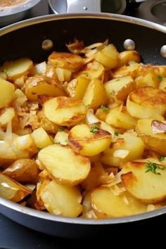 potatoes are being cooked in a pan on the stove