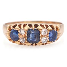 Weight: 2.9 Grams Stone: 1.16 TCW Sapphire and  Diamond (1.75mm) Asscher Cut Sapphire (4.5 x 4mm) at Center,  Two Oval Sapphires (3.5 x 3mm) Face of Ring: 16 x 6.4mm Ring Size:  6.75 Hallmark: 18, UK Origin Crown Stamp Item #: BR-1314-060724-19 Sapphire And Diamond Band, Diamond Band Ring, Asscher Cut, Stamp Art, Diamond Rings Bands, Diamond Bands, Band Rings, Favorite Jewelry, Jewelry Rings