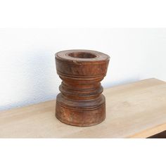 a wooden vase sitting on top of a table