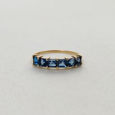 This stunning ring is set in 14k Solid Yellow Gold with Natural London Blue Topaz with utmost precision. It is an unique statement gemstone ring for nearly every occasion and is completely hassle-free jewelry. ITEM DETAILS *  GEM: London Blue topaz * GEM SIZE: 3mm * GEM SHAPE: Square 6pcs * Gem weight: 1.20 carats * Gold Purity: 14KT * Gold Weight: 1.17 gram * Total Weight of the Ring: 1.41 gram The Gold purity is guaranteed and it comes with authentic 14KT gold hallmark. Since my items are handmade, they are absolutely nickel and lead free. CUSTOMIZATION: * Size Customization is available for this ring and it is available in all ring sizes. Kindly choose your ideal ring size from the drop-down. * Gemstone customization is available and the it can be substituted with a gem of your choice. Blue Emerald Cut Topaz Ring In 14k Gold, Blue Emerald-cut Topaz Ring In 14k Gold, Blue Topaz Emerald Cut Rings, Blue Topaz 14k Gold Promise Ring, 14k Gold Topaz Ring With Sapphire Color, Blue Topaz Ring With Prong Setting In 14k Gold, 14k Gold Sapphire Topaz Birthstone Ring, Blue Birthstone Ring In 14k Gold As Gift, Blue 14k Gold Birthstone Ring Gift