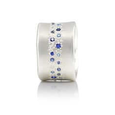 #MultiSapphire Two rows of bead set multi-sapphires are hand set around the center of this smooth sterling silver wide band. *We recommend you order 1-1.5 sizes up as this wider ring will feel smaller Sterling Silver Multisapphire Satin Finish Style sr589-17 #BlueSapphire Two rows of bead set sapphires are hand set around the center of this smooth sterling silver wide band. *We recommend you order 1-1.5 sizes up as this wider ring will feel smaller Sterling Silver Blue Sapphire Satin Finish Styl Multi Sapphire, Bead Set, Wide Rings, Engagement Ring Wedding Band, Wide Bands, Silver Blue, Wedding Ring Bands, Satin Finish, Stone Rings