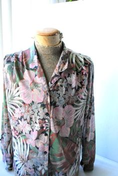 "Boho vintage 70s, soft, light polyester blouse. Made by Joanna in USA. Long sleeve. Couple pleats of the shoulder. V neck line with a collar. Closure up front with a tiny black, plastic buttons. Pastel watercolor print of the exotic flowers and leaves: lavender, pink, sage, olive green, brown, gray, beige, off white, black. Delicate, feminine, unique. Cute! Excellent condition, clean and strong inside and out. No any damage, no discoloration, no odor. Comfortable . Size 16. Length :24,0\" Shoul Vintage Tropical Print Tops For Spring, Vintage Tops With Tropical Print For Spring, Long Sleeve Blouse With Tropical Print For Spring, Bohemian Collared Blouse With Floral Print, Vintage Style Patterned Blouse With Floral Print, Tropical Multicolor Long Sleeve Blouse, Multicolor Tropical Long Sleeve Blouse, Multicolor Long Sleeve Tropical Blouse, Vintage Floral Print Patterned Blouse