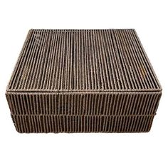 a brown wicker box sitting on top of a white surface