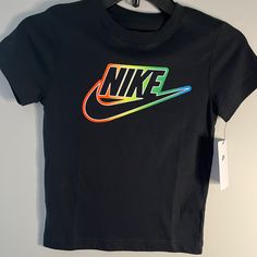 Boys Black And Neon Nike T-Shirt. Never Worn Multicolor Logo Print Short Sleeve Tops, Multicolor Short Sleeve Tops With Logo Print, Black Nike T-shirt With Letter Print, Nike Black T-shirt With Letter Print, Casual Multicolor Logo Print T-shirt, Casual Multicolor T-shirt With Logo Print, Multicolor Graphic Tee With Logo Print, Nike Short Sleeve T-shirt With Graphic Design, Nike Short Sleeve Tops With Graphic Design