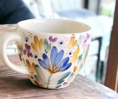 a coffee cup sitting on top of a wooden table