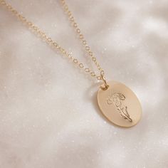 Delicate with a touch of whimsy, this hand-stamped pendant necklace features a flower design that represents your birth month. From the petite snowdrops of January to the classic holly of December, every month is represented (and some with two), making the Birth Month Necklace a great gift for moms, grandparents and friends, or any nature lover in your life. We love the subtle femininity it offers on its own, but because the oval pendant is suspended from a dainty gold chain that falls just belo Daisy May, Dainty Gold Chain, Birth Month Flower, Month Flowers, Great Gifts For Mom, Birth Month Flowers, Oval Pendant, Birth Month, Every Month