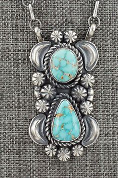 This stunning natural Sonoran turquoise and sterling silver necklace was made by Navajo silversmith Jeff James. The back is signed JJJ and stamped sterling.Necklace: 20" with additional 2" extender chainPendant Length: 2"Pendant Width: 1 1/8"Free shipping on all orders! We ship with USPS and always include tracking. All orders ship within a day of payment.Returns are accepted up to 30 days after you receive your order. Just send us a message. Our shop offers cash back or store credit. The item m Western Sterling Silver Turquoise Necklace, Western Style Sterling Silver Turquoise Necklace, Western Style Collectible Turquoise Sterling Silver Necklace, Sterling Silver Turquoise Necklace With Concho, Concho Sterling Silver Necklace For Gifts, Sterling Silver Concho Necklace For Gift, Southwestern Sterling Silver Concho Necklace, Western Sterling Silver Turquoise Pendant Necklace, Western-style Sterling Silver Turquoise Pendant Necklace