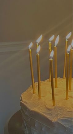 a birthday cake with seven lit candles on it