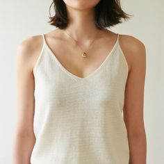 Sleeveless linen knit tank, perfectly worn in shirt with high quality stitching. Feels soft to the touch and is perfect for summer. Model is wearing MINUSEY ONE SIZE. Please allow 5-12 days shipping when in restocking.* MINUSEY ONE SIZE = EU 34-38, US 2-6* 60% Linen / 20% Rayon / 20% Acrylic* Dry clean* Made in Korea - Model Height: 171cm/5'7" (US 2, EU 34) Summer Everyday Knit Tank Top, Everyday Summer Knit Tank Top, Spring Layering Fine Knit Tank Top, Chic Summer Knit Top For Everyday, Minimalist Sleeveless Top For Everyday, Everyday Fine Knit V-neck Tops, Minimalist Summer Tank Top For Everyday, Minimalist Sleeveless Tank Top For Everyday, Summer Linen Knit Top