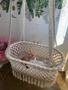 a baby is laying in a hammock swing