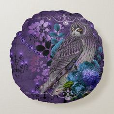 an owl sitting on top of a purple paper plate with flowers and leaves around it