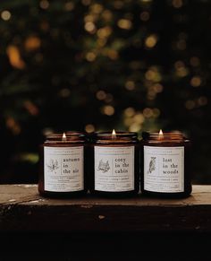 three candles sitting on top of a wooden table