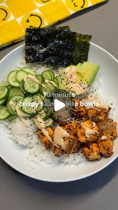 a white plate topped with rice and veggies