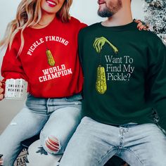 Celebrate the quirky tradition of the Christmas pickle hiding game with this hilarious couple's ugly Christmas sweater set! One sweater proudly declares "Pickle Finder World Champion," while the other playfully asks, "Want to Find My Pickle?" Perfect for couples who love to embrace holiday traditions with a twist, these sweaters are sure to bring laughter and fun to any Christmas gathering. Made from soft, cozy fabric, they ensure comfort while you join in the festive spirit. Whether you're look Ugly Christmas Sweater Ideas For Couples, Matching Christmas Outfits For Couples, Christmas Pickle Tradition, Couples Christmas Sweaters, Matching Christmas Sweaters, Ugly Christmas Sweater Couples, Matching Christmas Outfits, Christmas Pickle, Couples Christmas