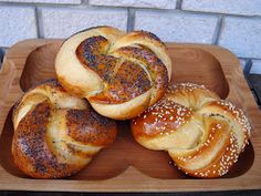 four loaves of bread on a wooden tray