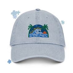 Unique, unisex pigment dyed denim dad hat with 'ride the wave' beach palm tree embroidered design. This hat is soft and lightweight, and is the perfect, easy accessory to add to almost any outfit. It would make a great gift or beach hat too! * 100% cotton * 6-panel unstructured cap with a low profile * Soft crown * Adjustable strap * Head circumference: 21.65″-25.19″ (55 cm-64 cm) Cotton Snapback Trucker Hat For Vacation, Beach Dad Hat With Flat Bill, Trendy Beach Baseball Cap With Curved Bill, Blue Cotton Trucker Hat For The Beach, Trendy Cotton Trucker Hat For Beach, Cotton Trucker Hat For Vacation, Summer Streetwear Hats With Curved Bill, Trendy Curved Bill Baseball Cap For Beach, Trendy Cotton Snapback Hat For Beach