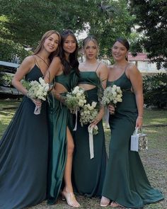 the bridesmaids are all dressed up in green gowns and holding bouquets