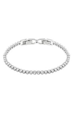 Bezel set crystals line up to stream shine all around this delicate, light-catching bracelet. 6 7/8" length Fold-over clasp Rhodium plate/Swarovski crystal Imported Formal Adjustable Crystal Tennis Bracelet, Birthday Fits, Swarovski Ring, Wrist Wear, Classic Bracelets, Pretty Necklaces, Womens Designer Fashion, Tennis Bracelet, Blue Crystals