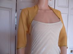 This is a beautiful hand made gold chiffon shrug ideal for weddings or special occasions. It can also be worn with casual wear. It can be made in any size from 8 to 24 (UK sizes). It is made in the UK. It is normally sent out to you within 5 days, but I am very happy to make your order a priority if you need it urgently. Just let me know the date needed by. Postage is free in the UK! International postage is £9. I am happy to exchange items or refund your payment if you are less than happy with Spring Formal Fitted Shrug, Chic Stretch Shrug For Party, Summer Party Shrug With Stretch, Stretch Summer Party Shrug, Elegant Stretch Shrug For Spring, Elegant Open Front Summer Shrug, Chic Fitted Shrug For Evening, Chic Fitted Evening Shrug, Chic Fitted Summer Shrug