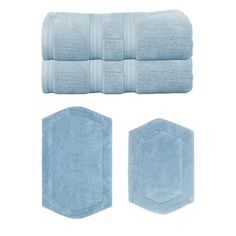 towels and rugs in light blue on a white background with two hexagon shaped mats