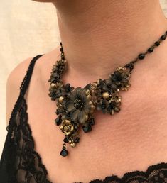 Very pretty black and gold necklace with hand painted resin flowers in shades of black to gold. The necklace part is beaded with jet colored glass beads. A gorgeous central gold rose and jet black drops finish off this necklace. Stunning This is a quality piece of jewelry that will last a life time. Created by designer Colleen Toland who has been creating her unique style of vintage jewelry for more than 30 years. All of our pieces come with an engraved tag with Colleen's name so as you know you Gold Bohemian Flower Necklace For Party, Antique Black Beaded Necklaces, Antique Black Beaded Necklace, Elegant Gold Flower Beaded Necklaces, Handmade Gold Flower Necklace For Party, Antique Black Necklace For Party, Antique Black Party Necklace, Black Bohemian Flower Necklace, Bohemian Black Flower Necklace