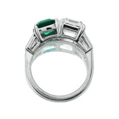 Asscher Diamond and Emerald Toi et Moi Ring The Braxton 2.90 ring is an AB original design made right here in NYC. The ring features a GIA-certified 2.90-carat Asscher Cut diamond of J color, VS1 clarity and a 1.68-carat C Dunaigre-certified Octagonal cut Zambian Emerald with minor enhancement. On either side of the stones are tapered baguette diamonds totaling approximately 0.40 carats. The stones are set in a platinum setting. The ring is currently size 6 and can be resized! Why We Love It A p Luxury Emerald Three Stone Ring For Formal Occasions, Luxury Three Stone Emerald Ring For Formal Events, Luxury Three Stone Emerald Ring For Formal Occasions, Timeless Three Stone Emerald Ring For Formal Occasions, Gia Certified Platinum Emerald Cut Rings, Formal Three Stone Emerald Ring In Fine Jewelry Style, Gia Certified Classic Emerald Ring, Formal Three Stone Emerald Ring, Formal Polished Platinum Emerald Ring