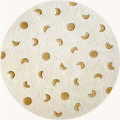 a white circle with gold polka dots on the top and bottom, as if it were made out of paper