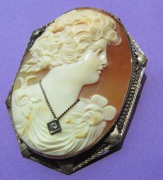 Antique Cameo Brooch 14 Karat Gold With Diamond Estate Floral Lady Shell Circa 1900 This is a stunning antique 14 Karat white gold and hand carved shell cameo circa 1900,which can be worn as either a brooch or pedant. Excellent well carved and detailed shell cameo depicting a flowing haired woman. She has flowers both on her gown in in her hair. She wears a genuine diamond necklace. No cracks or chips. The setting is in lovely 14 karat white gold, marked 14K the c clasp. Measures 2 1/8 inches ta Antique Pins, Leaf Bracelet, Carved Shell, Diamond Brooch, Cameo Brooch, Diamond Fashion, Jewelry Art, Brooches, Diamond Necklace