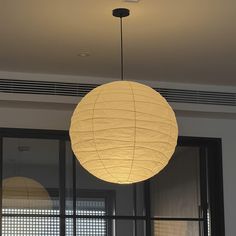 a large white paper lantern hanging from the ceiling